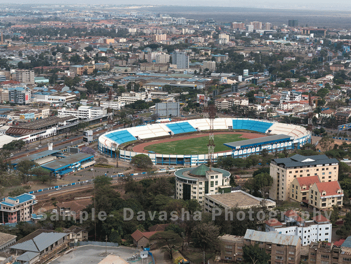 stadium, aerial view, houses, buildings, infrastructure, rooftop, urban, developing, busy, industrious, settlements, road, urbanization, transport, motor vehicles, cityscape, housing, transmitter, grass, billboard